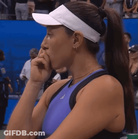 A Woman Wearing A Purple Tank Top And A White Visor Is Covering Her Mouth GIF