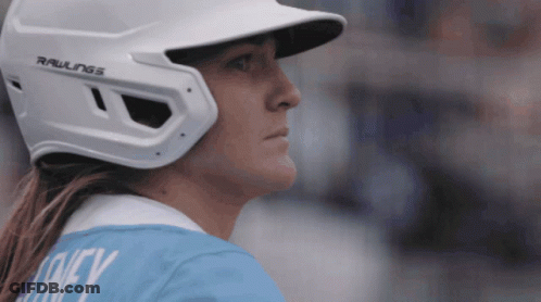 A Woman Wearing A Rawlings Baseball Helmet Looks Down GIF