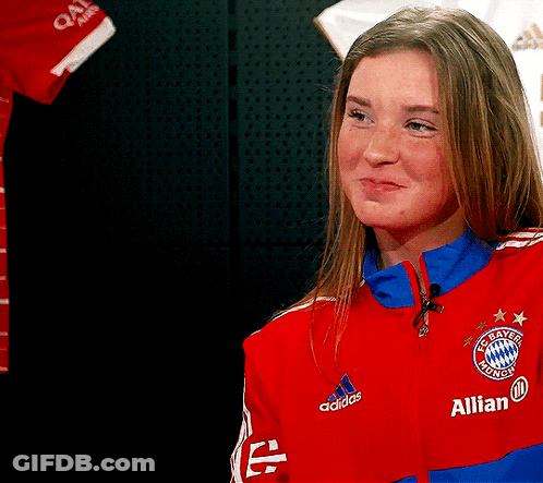 A Woman Wearing A Red Adidas Jacket With The Word Allian On It GIF