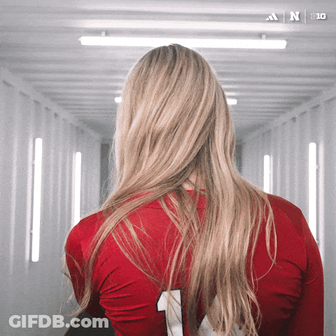 A Woman Wearing A Red Adidas Jersey With The Number 1 On It GIF