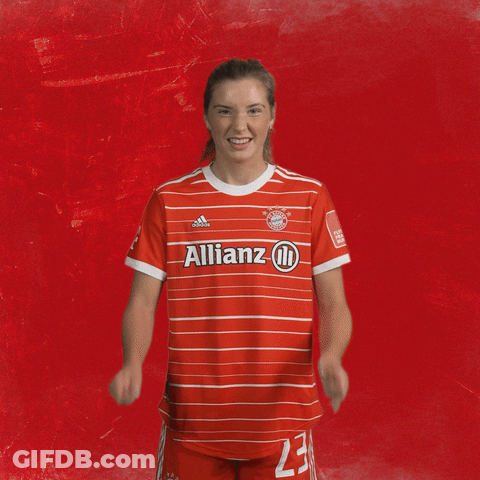 A Woman Wearing A Red Allianz Jersey With The Number 23 On It GIF