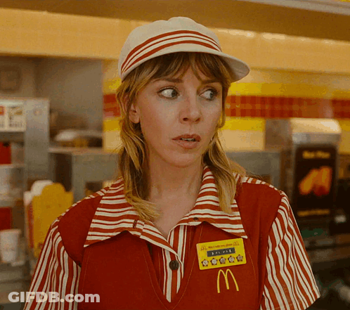 A Woman Wearing A Red And White Striped Mcdonald 'S Uniform With A Yellow Mcdonald 'S Badge GIF