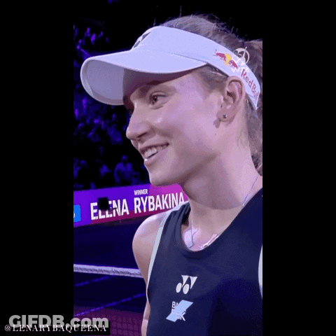 A Woman Wearing A Red Bull Headband Is Smiling GIF