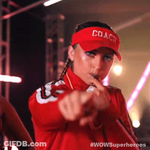 A Woman Wearing A Red Coach Hat Is Pointing Her Finger GIF