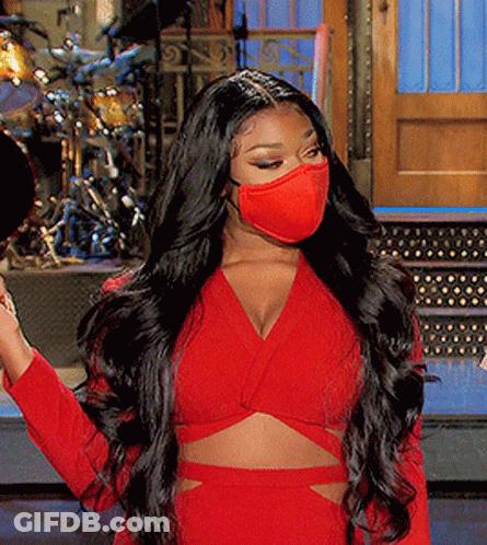 A Woman Wearing A Red Crop Top And A Red Face Mask GIF
