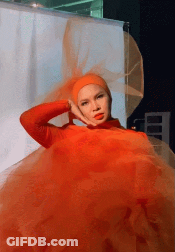 A Woman Wearing A Red Dress And A Hijab GIF