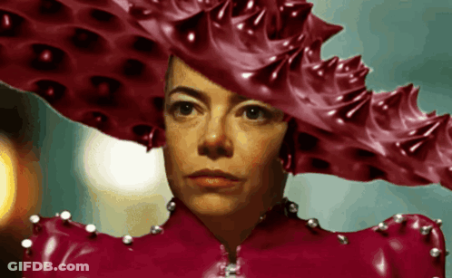 A Woman Wearing A Red Hat And A Red Latex Dress GIF