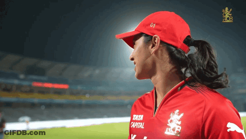 A Woman Wearing A Red Hat And A Red Shirt That Says Tata Capital GIF