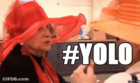 A Woman Wearing A Red Hat And A Yellow Hat Says # Yolo GIF
