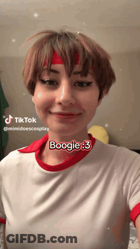 A Woman Wearing A Red Headband And A White Shirt Says Boogie On Her Face GIF