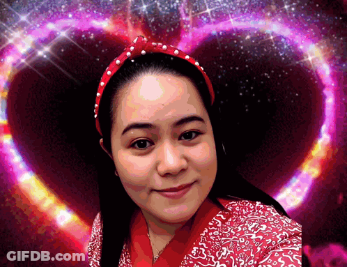 Woman With Red Headband Smiling In Front Of Heart GIF
