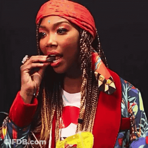 Woman Eating Chocolate Bar In Red Jacket GIF