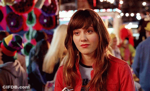 A Woman Wearing A Red Jacket And A T-Shirt That Says ' Rsfw ' On It GIF