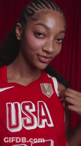 A Woman Wearing A Red Jersey That Says Usa On The Front GIF