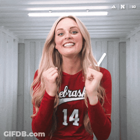 A Woman Wearing A Red Jersey With The Number 14 GIF