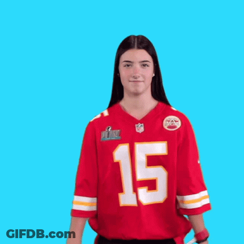 A Woman Wearing A Red Jersey With The Number 15 On It Is Dancing GIF