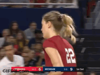 A Woman Wearing A Red Jersey With The Number 22 On The Back GIF