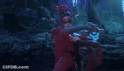 A Woman Wearing A Red Mask Is Holding A Sword GIF