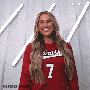 A Woman Wearing A Red Nebraska Jersey Number 7 GIF