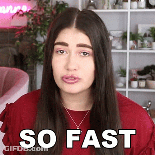 A Woman Wearing A Red Shirt And Necklace Says So Fast GIF