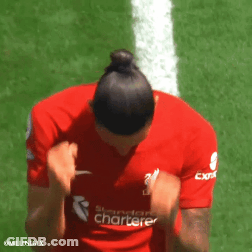 A Woman Wearing A Red Shirt That Says Standard Chartered GIF
