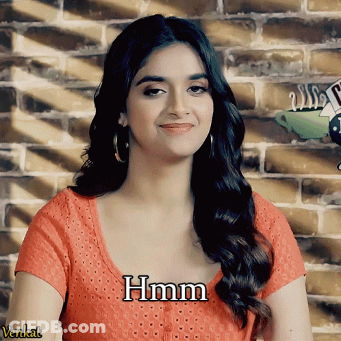 A Woman Wearing A Red Shirt With The Word Hmm Written On It GIF