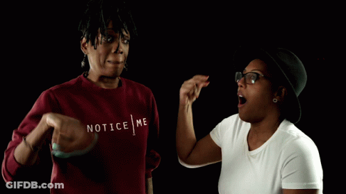 A Woman Wearing A Red Sweater That Says Notice Me On It GIF