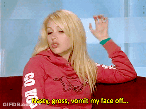 A Woman Wearing A Red Sweatshirt That Says Go Hawks On The Sleeves GIF
