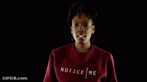A Woman Wearing A Red Sweatshirt With The Word Tic On The Front GIF