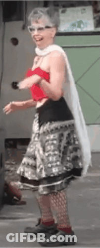 Woman In Red Top And Gray Skirt On Street GIF