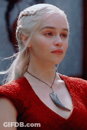 A Woman Wearing A Red Top And A Necklace With A Claw On It GIF