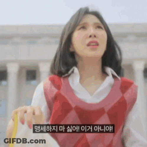 A Woman Wearing A Red Vest And A White Shirt Is Holding A Yellow Object . GIF