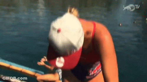 A Woman Wearing A Red White And Blue Hat Is In The Water GIF
