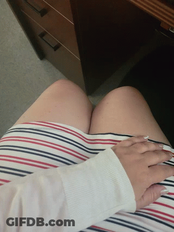 A Woman Wearing A Red White And Blue Striped Skirt Holds Her Hands To Her Chest GIF