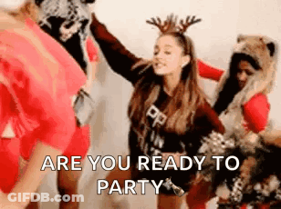 A Woman Wearing A Reindeer Headband Is Dancing With A Group Of People . GIF