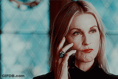 A Woman Wearing A Ring Talks On A Cell Phone GIF