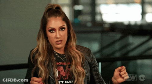 A Woman Wearing A Rolling Stones T-Shirt Is Making A Face GIF