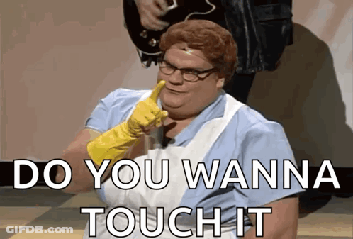 A Woman Wearing A Rubber Glove Says " Do You Wanna Touch It " In Front Of A Man Playing A Guitar GIF
