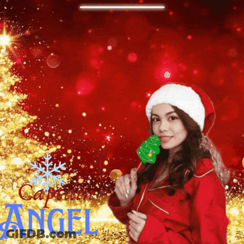 A Woman Wearing A Santa Hat Is Holding A Christmas Tree Shaped Lollipop GIF