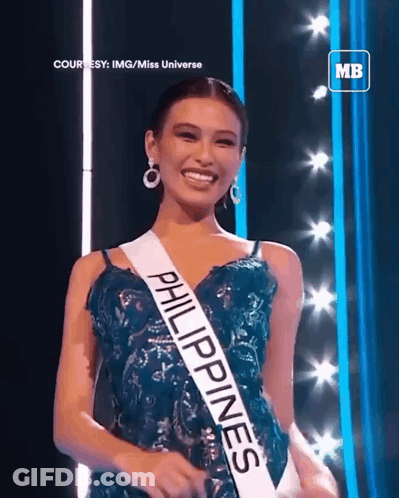 A Woman Wearing A Sash That Says Philippines Is Smiling GIF