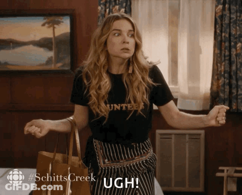 Woman In Counter Shirt Holding Ugh GIF