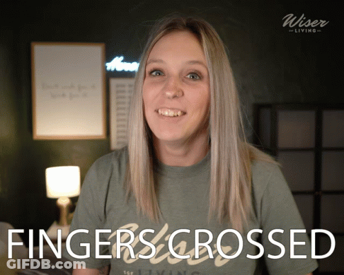 A Woman Wearing A Shirt That Says Fingers Crossed On It GIF