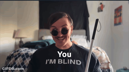 A Woman Wearing A Shirt That Says You 'Re Blind GIF