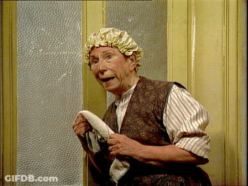 A Woman Wearing A Shower Cap Holds A Towel In Her Hands GIF