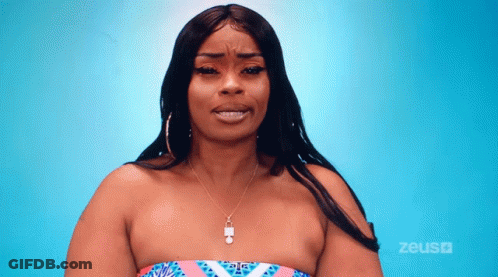 A Woman Wearing A Strapless Top And A Necklace Is Standing In Front Of A Blue Background That Says Zeus On It GIF