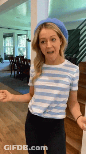A Woman Wearing A Striped Shirt And A Blue Beret GIF