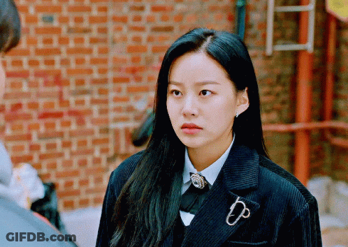 A Woman Wearing A Suit With A Brooch That Says Dp On It GIF