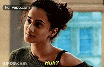 A Woman Wearing A Sweater And A Black Bra Is Talking To Another Woman . GIF