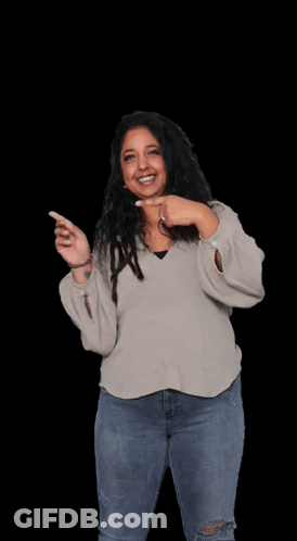 A Woman Wearing A Sweater And Jeans Is Pointing At Herself . GIF