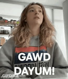 A Woman Wearing A Sweater That Says Gawd Dayum GIF